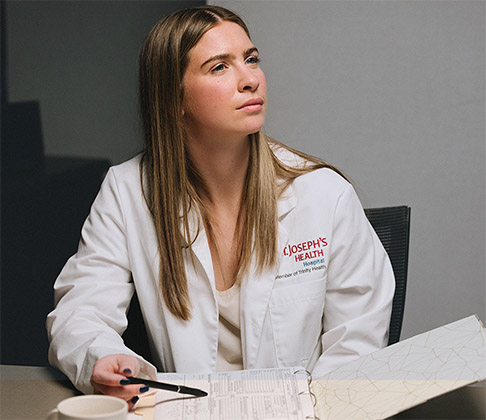 A physician assistant at St. Joseph's Health participates in a collaborative discussion about patients' cancer care options.